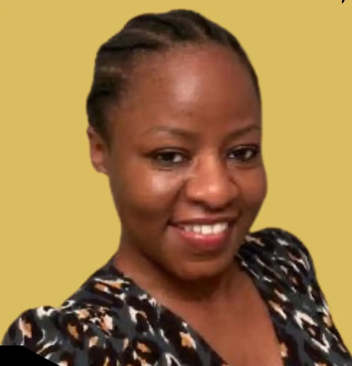 Kika Otieno, the keynote speaker, smiling, with braided hair and a patterned top against a yellow background