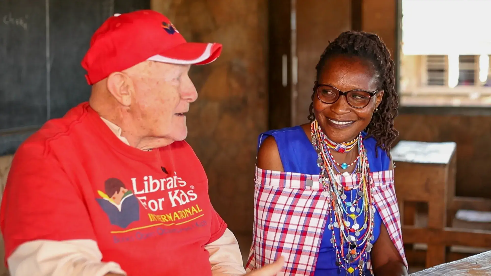 Coach Roy Austin with a teacher in traditional beadwork